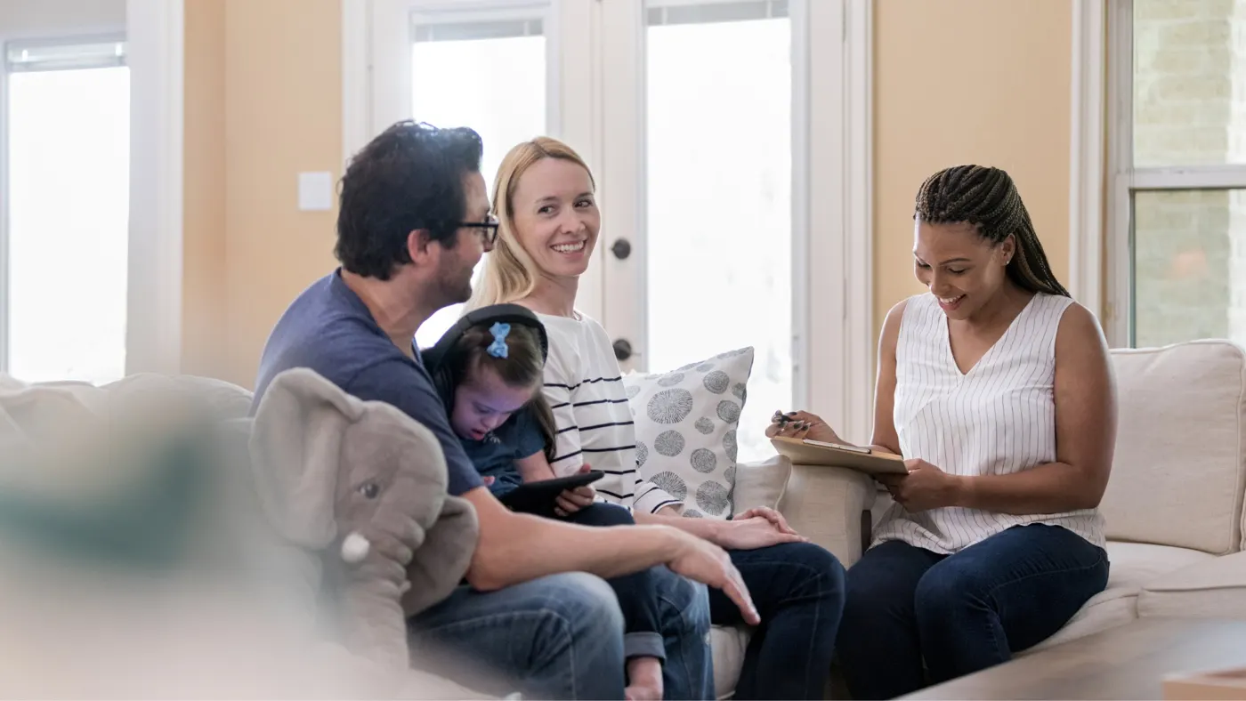 A support coordinator meeting with a family at home